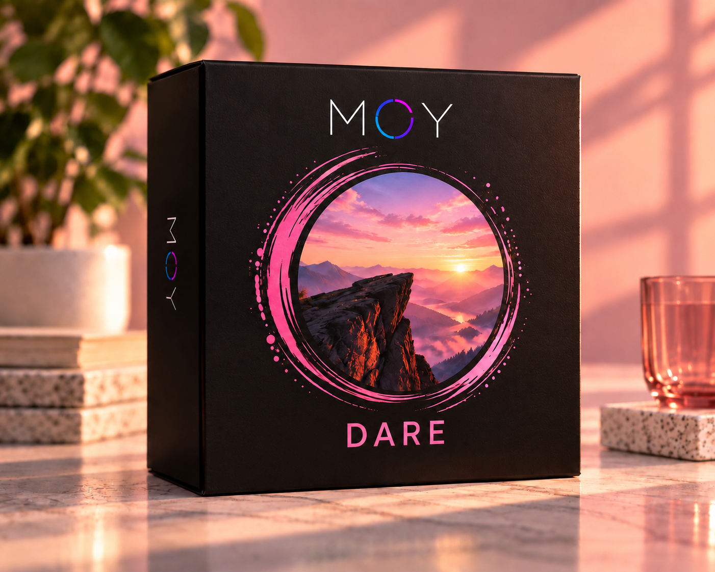 The black MOY DARE box with pink-ringed mountain cliff artwork.